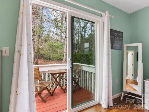a view of a balcony with wooden floor