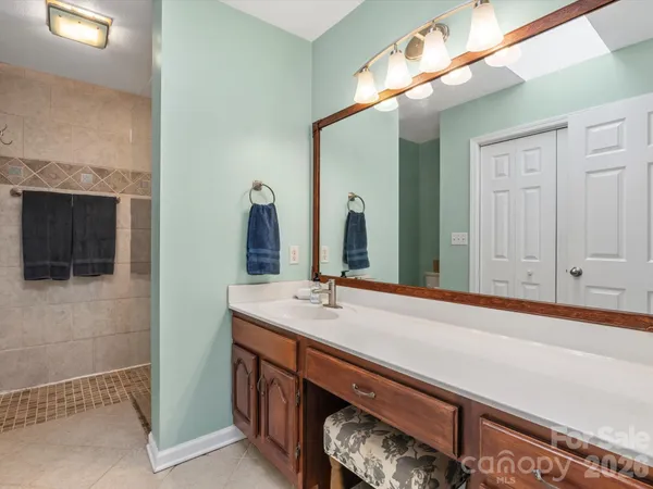 a bathroom with a sink a vanity and a mirror
