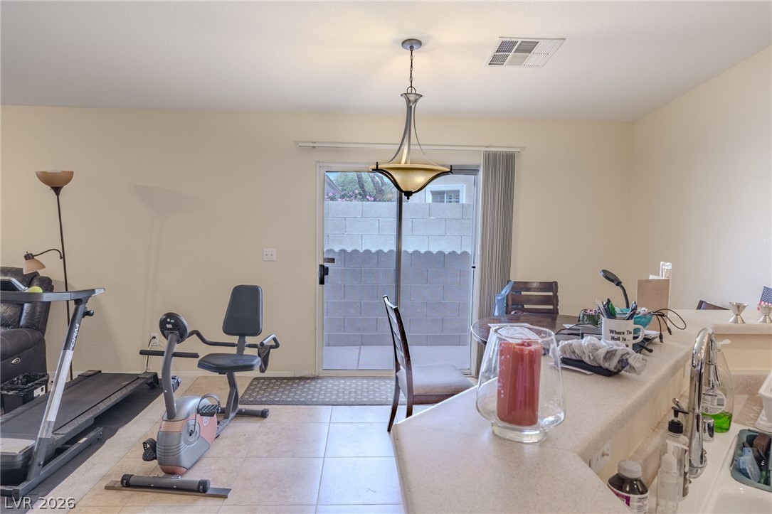 4994 Mascaro Drive Las Vegas, NV 89122 - Photo 4 of 30 The kitchen and dining area flows seamlessly into the private outdoor patio through sliding glass doors.