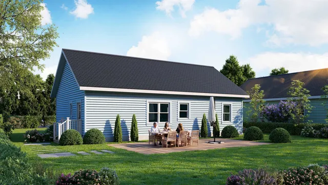 a backyard of a house with table and chairs plants and large tree