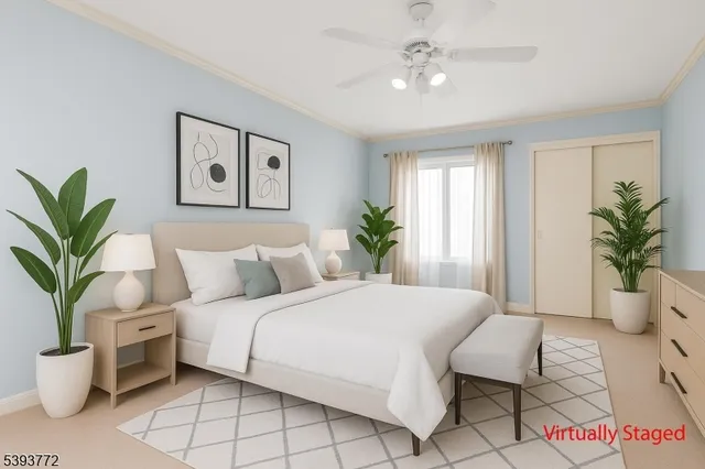 a bedroom with a large bed and a potted plant