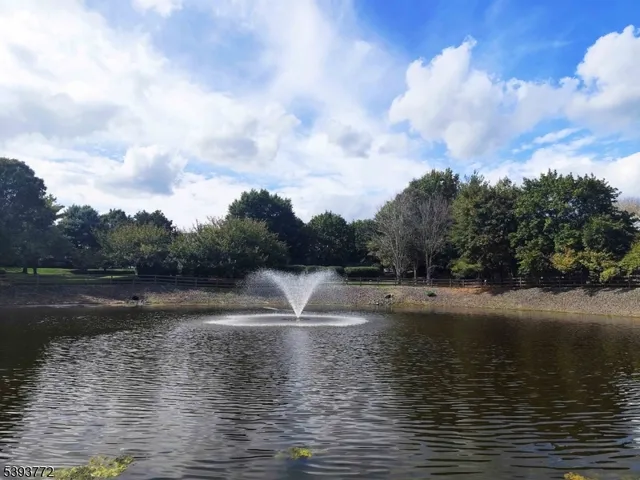 a view of water with water fall and green space
