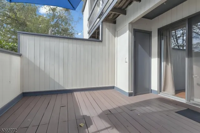 a view of outdoor space with wooden floor and windows