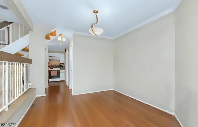 a view of a hallway view with wooden floor and staircase
