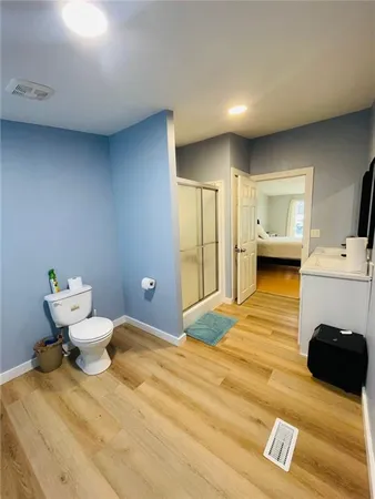 a bathroom with a sink a toilet and shower