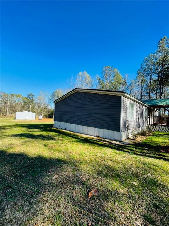 489 Childers Road Colbert, GA 30628 - Photo 21 of 30 a view of a swimming pool with an outdoor seating and a yard