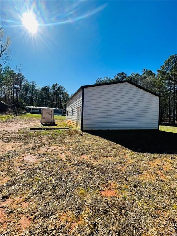 489 Childers Road Colbert, GA 30628 - Photo 28 of 30 a backyard of a house with large trees