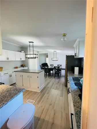 a kitchen with white cabinets