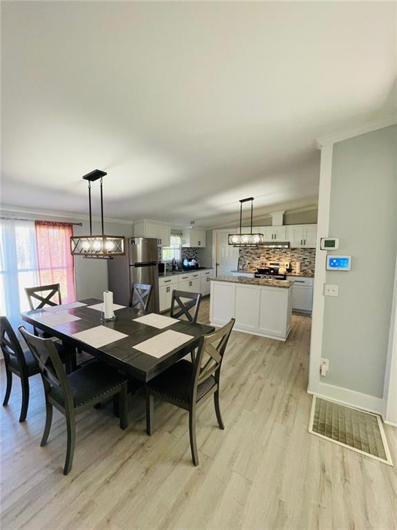 489 Childers Road Colbert, GA 30628 - Photo 8 of 30 a dining room with a table and chairs