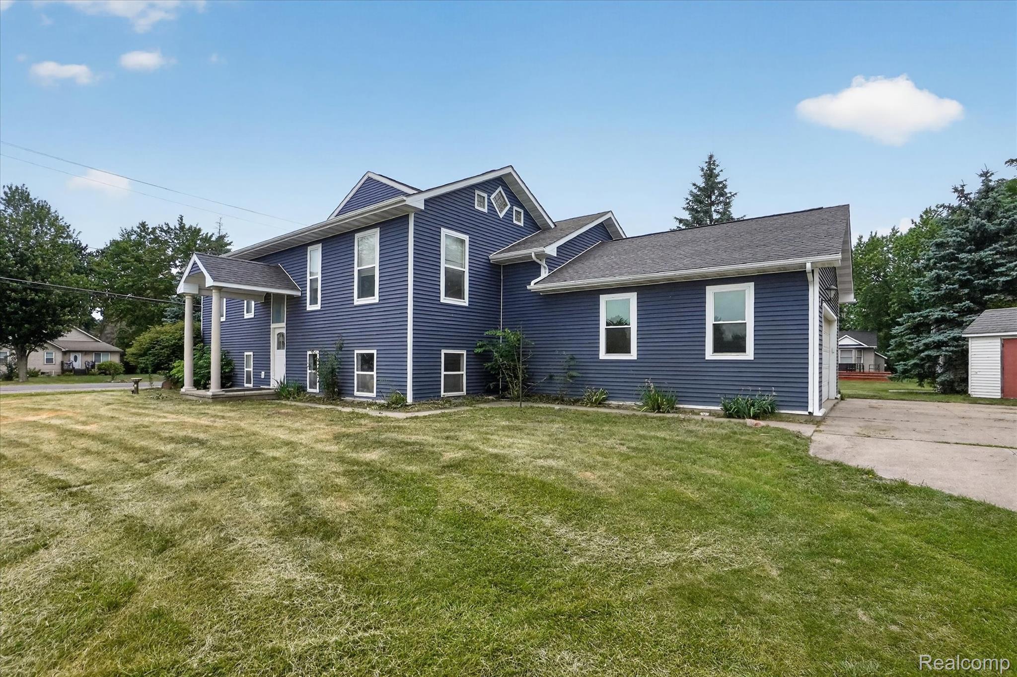 6524 Kelly Road Flushing, MI 48433 - Photo 2 of 47 Deep blue siding exterior with white trim