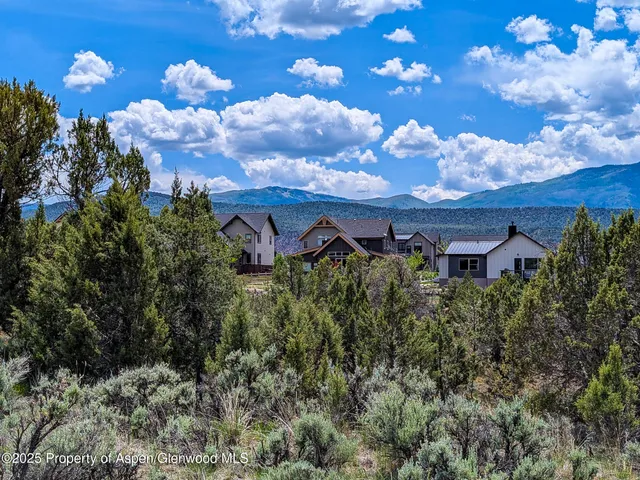a view of a house with a yard and garden