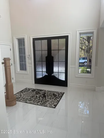a kitchen with granite countertop a sink and white cabinets