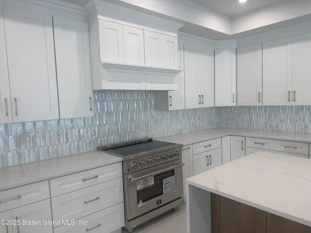 a kitchen with granite countertop a sink and cabinets