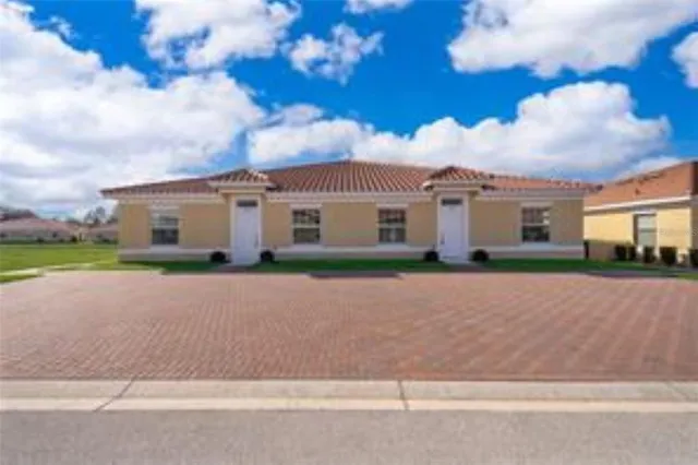 a front view of house with yard and green space