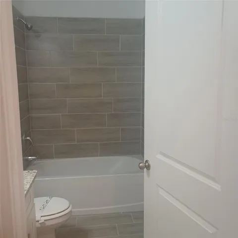 a bathroom with a bathtub and a toilet