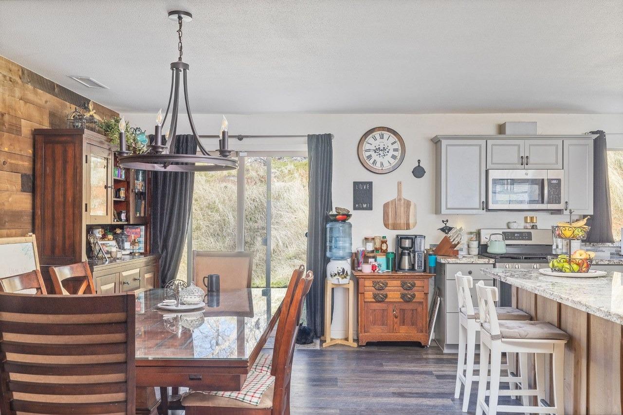 36820 Mudge Ranch Road Coarsegold, CA 93614 - Photo 18 of 75 a view of a dining room and livingroom with furniture wooden floor a chandelier