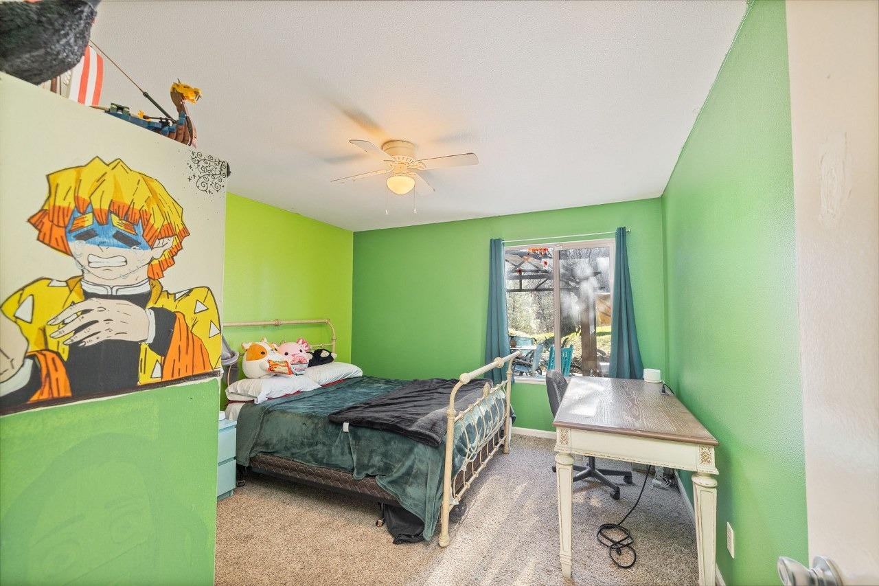 36820 Mudge Ranch Road Coarsegold, CA 93614 - Photo 32 of 75 a bedroom with a bed and a table in it