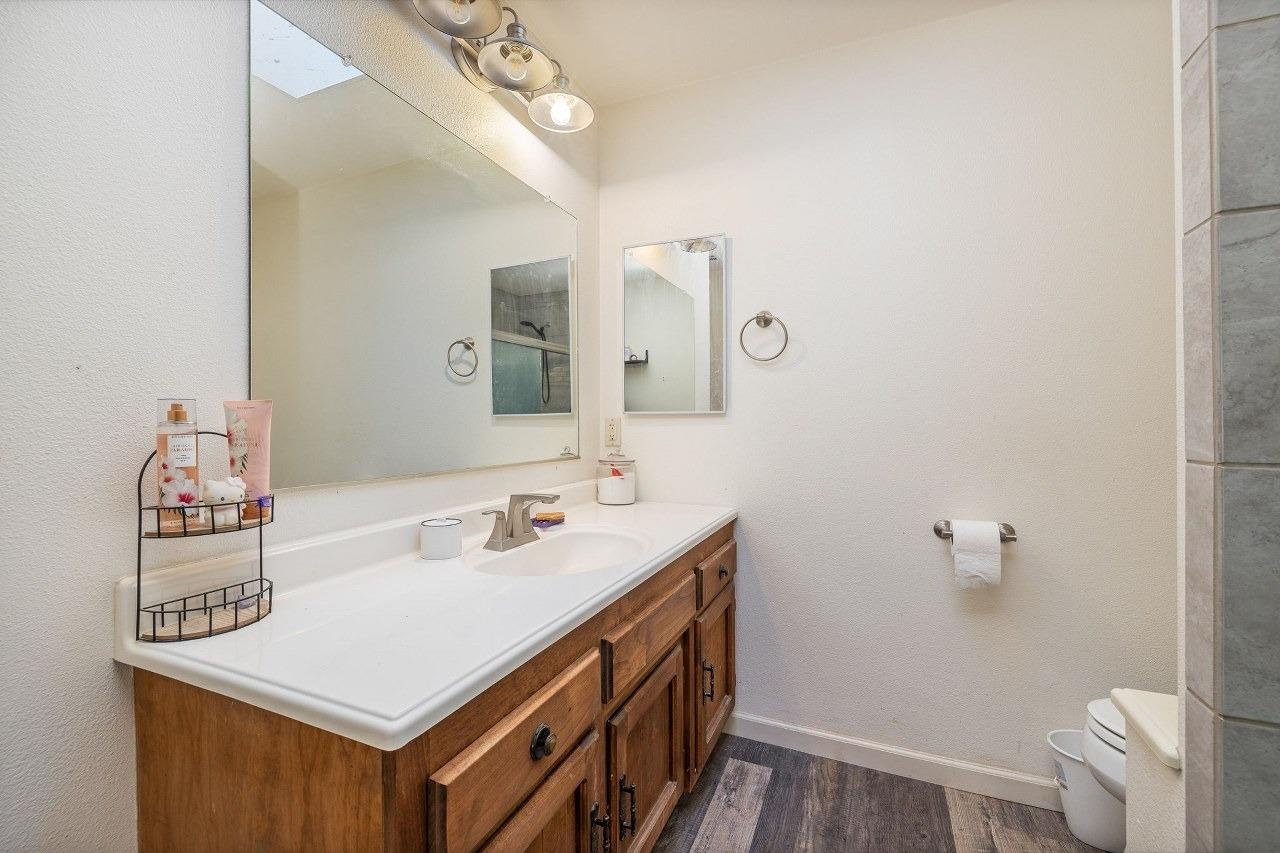 36820 Mudge Ranch Road Coarsegold, CA 93614 - Photo 39 of 75 a bathroom with a sink a toilet and a mirror