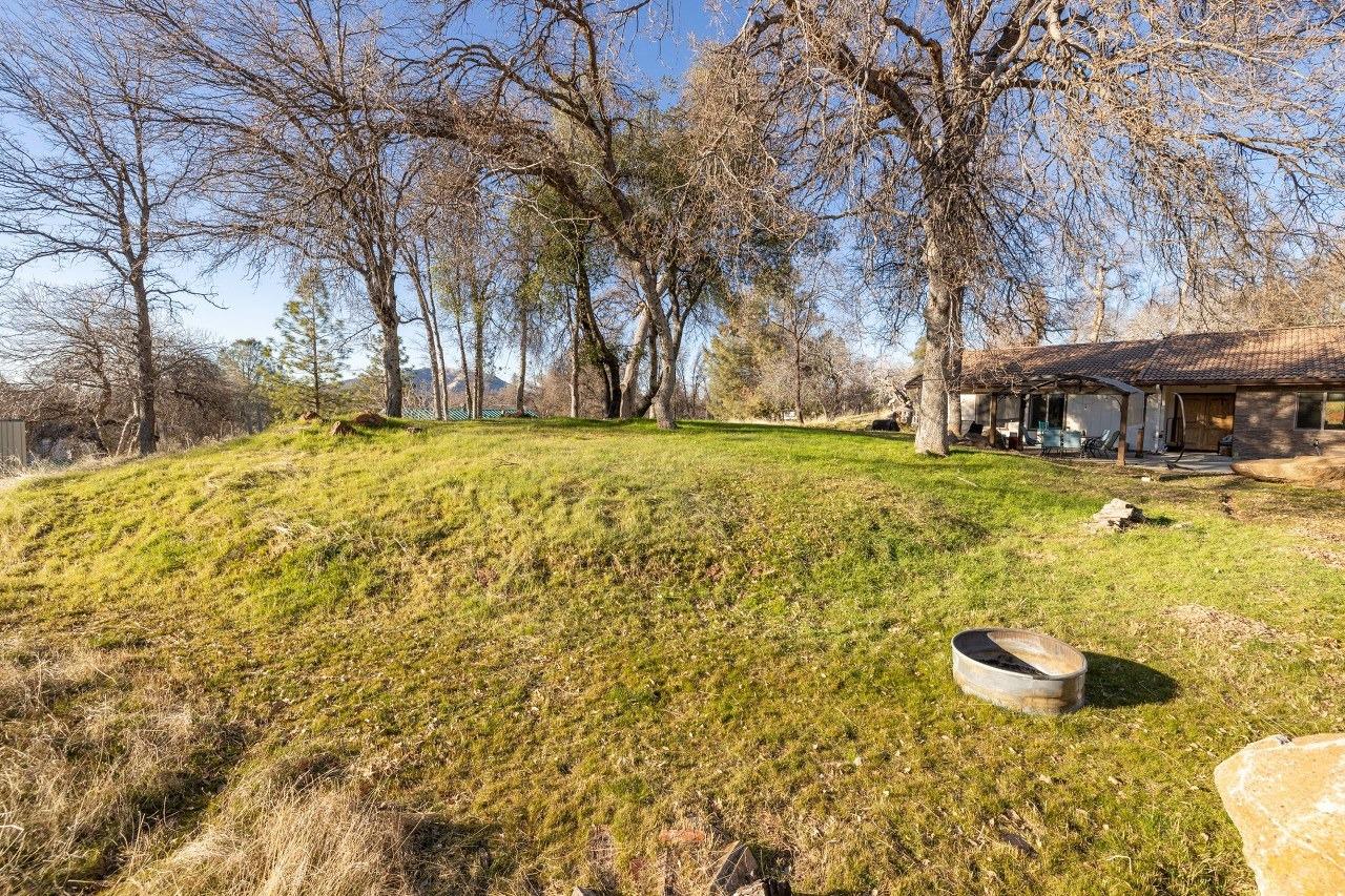 36820 Mudge Ranch Road Coarsegold, CA 93614 - Photo 62 of 75 a swimming pool with outdoor seating and yard