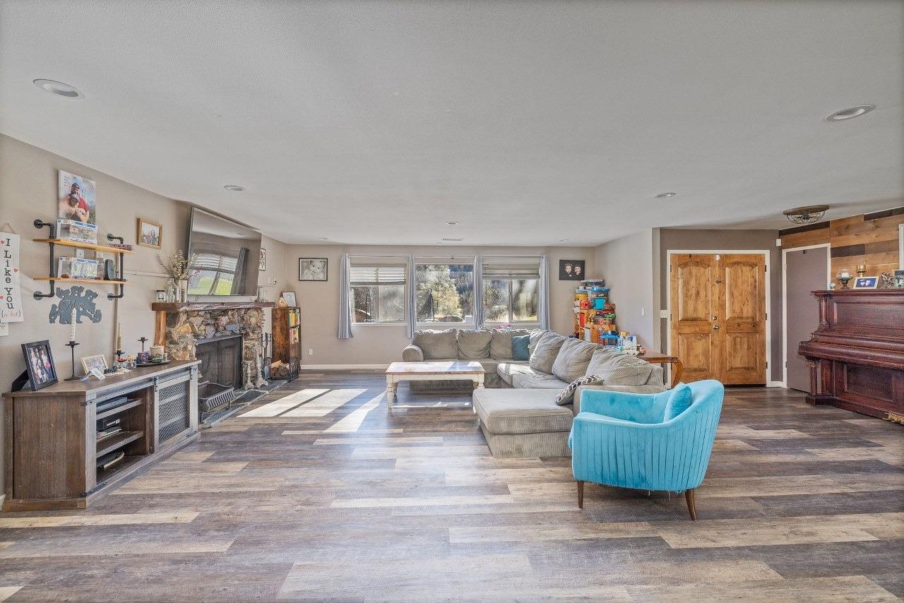 36820 Mudge Ranch Road Coarsegold, CA 93614 - Photo 10 of 75 a living room with furniture and a fireplace