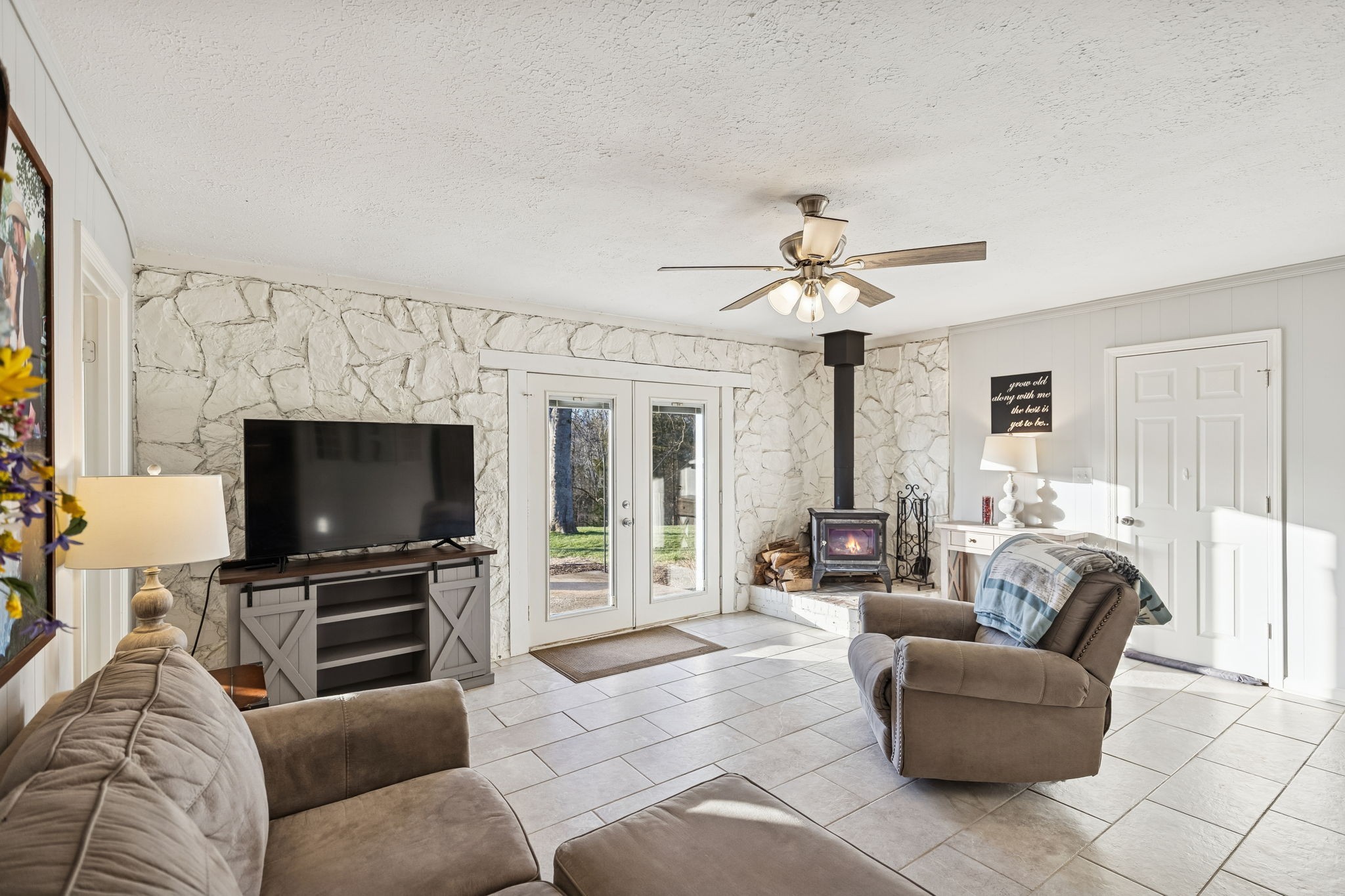 2370 Patton Hollow Road Watertown, TN 37184 - Photo 16 of 50 a living room with furniture a flat screen tv and a fireplace