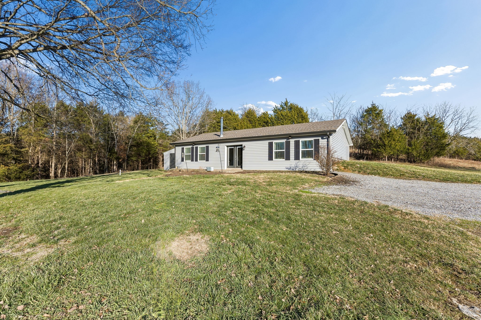 2370 Patton Hollow Road Watertown, TN 37184 - Photo 25 of 50 a view of a house with a yard and potted plants