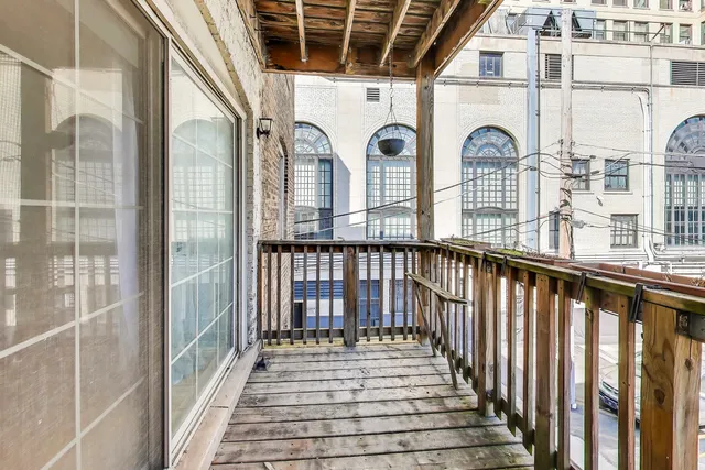 a view of a brick house with wooden floor and a large window