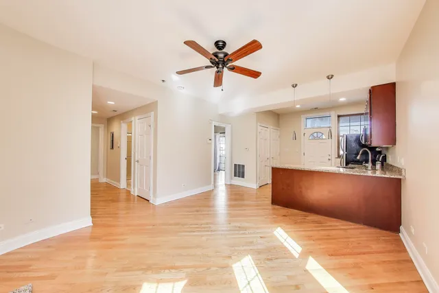 a view of a living room a window and a ceiling fan