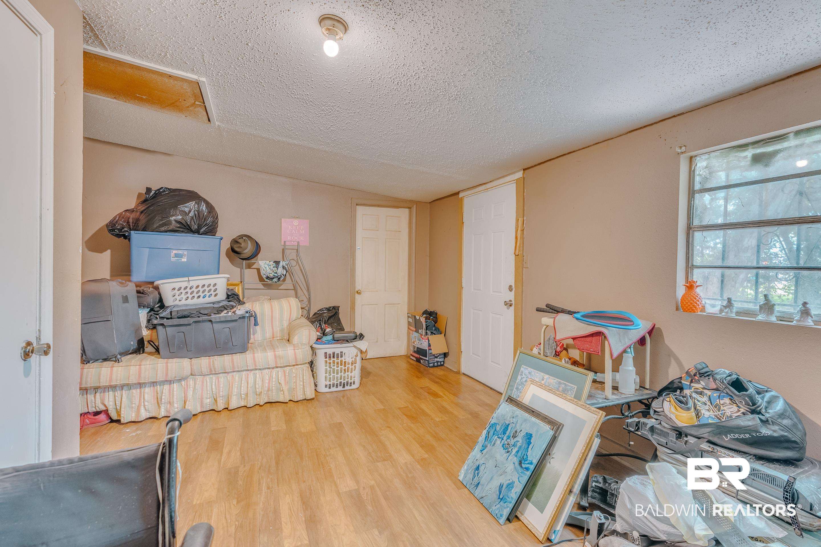 1156 Freeman Street Mobile, AL 36605 - Photo 11 of 22 Interior space featuring a textured ceiling and wood finished floors