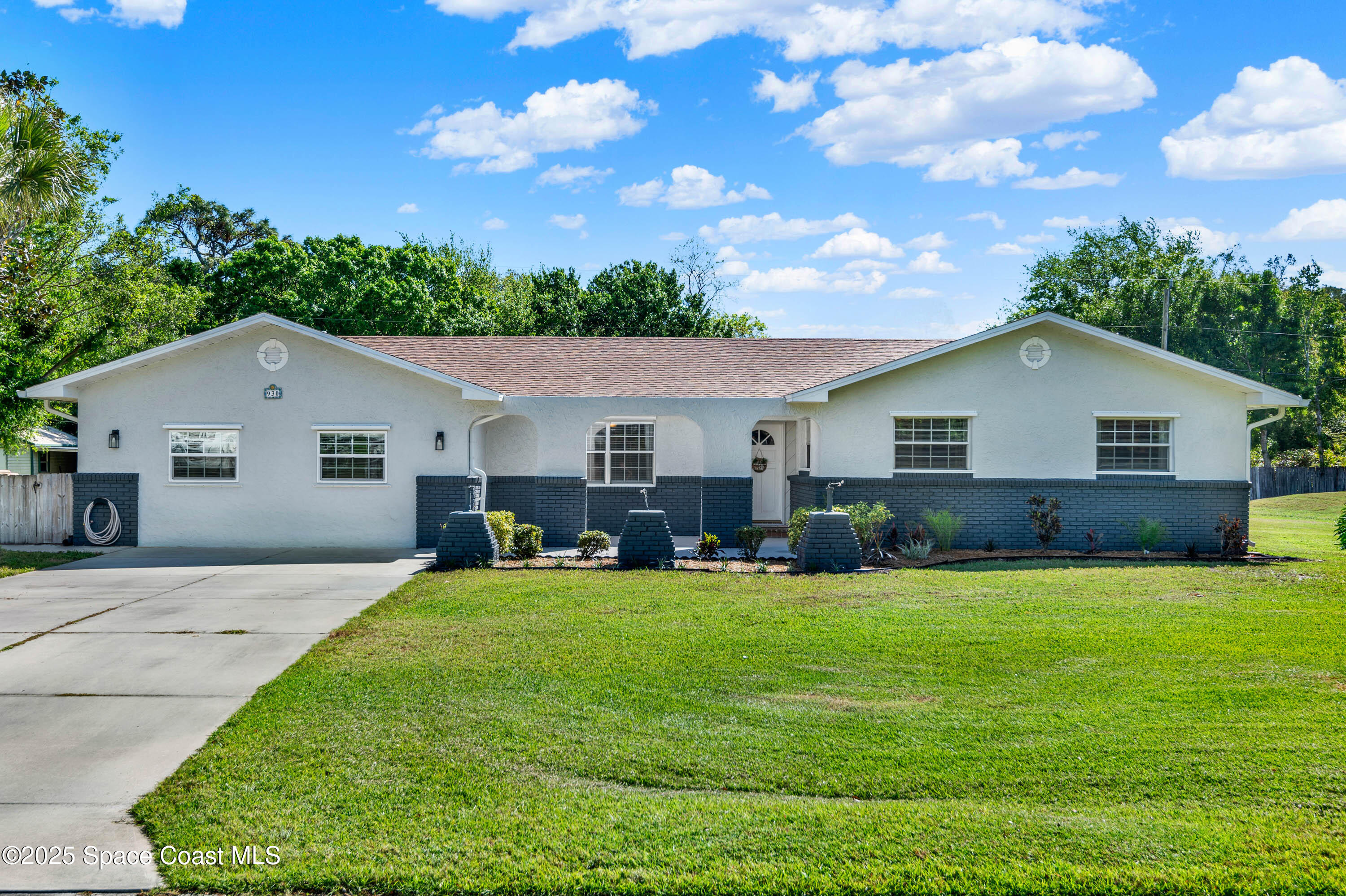 a front view of house with yard and green space