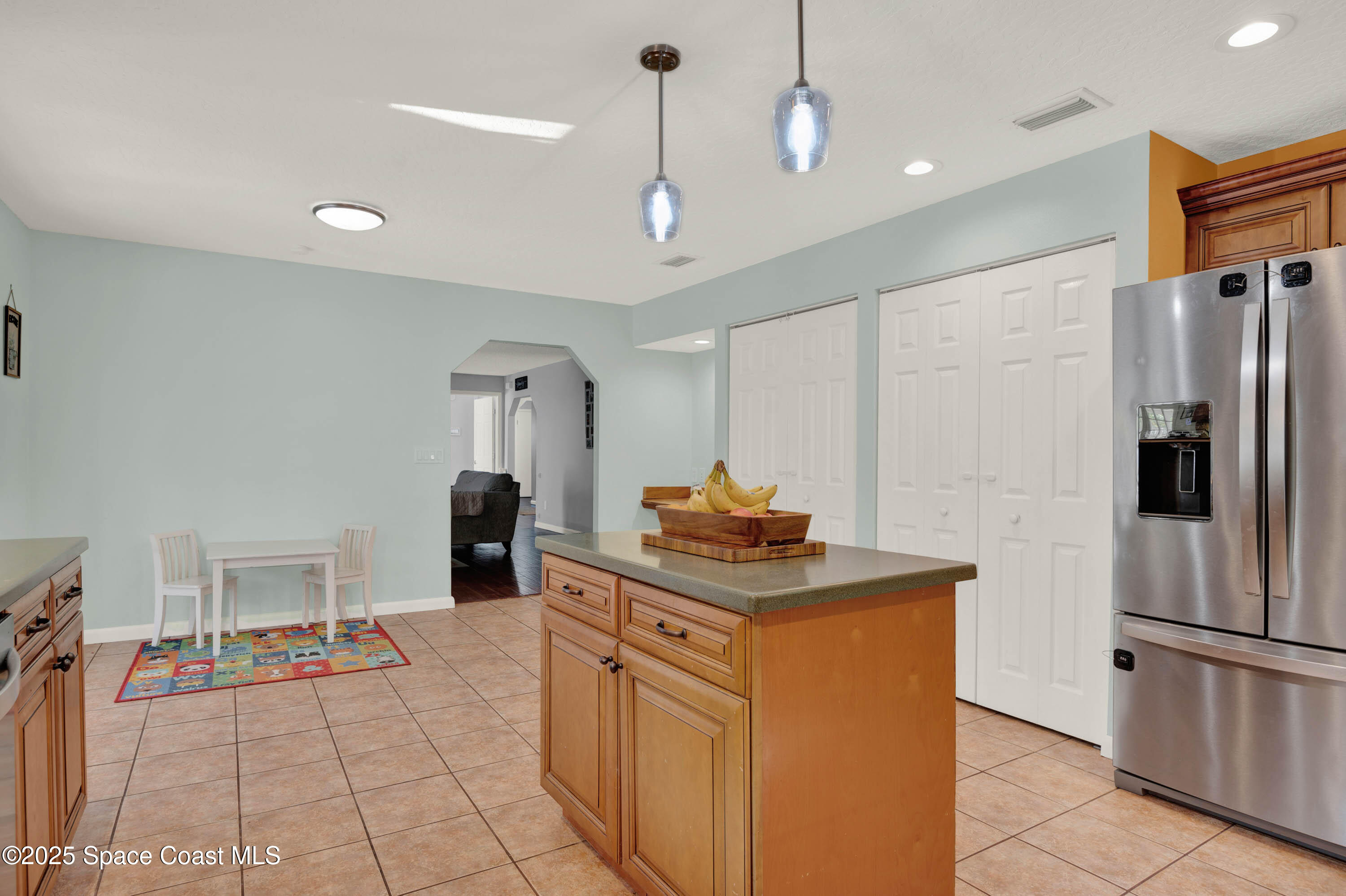 930 Miller Lane Melbourne, FL 32934 - Photo 11 of 40 a kitchen with stainless steel appliances granite countertop a refrigerator a sink and a stove