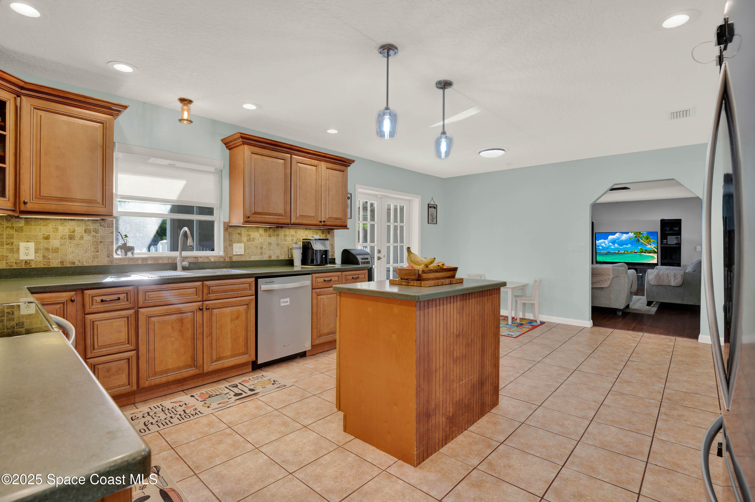 930 Miller Lane Melbourne, FL 32934 - Photo 12 of 40 a kitchen with stainless steel appliances granite countertop a refrigerator a sink dishwasher a oven with white cabinets and countertops