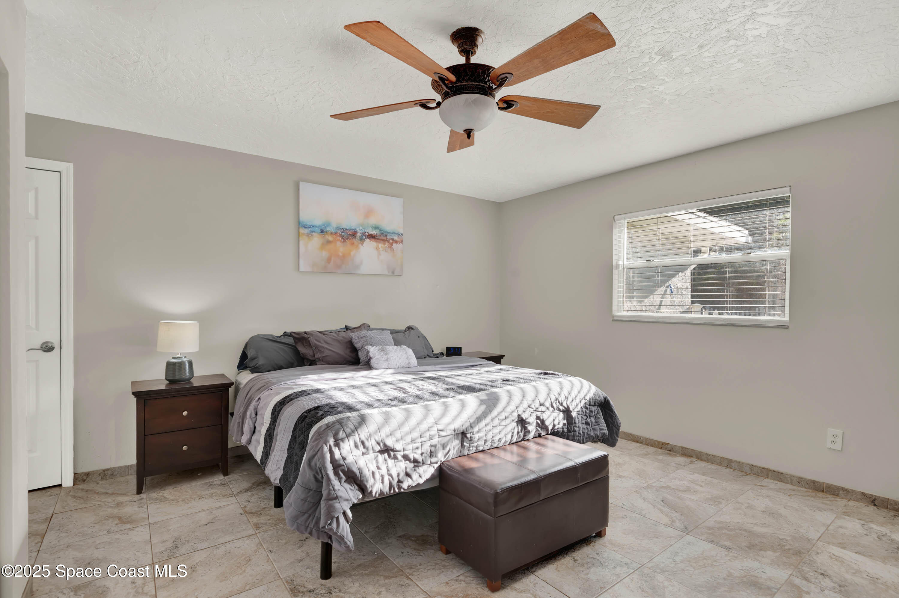 930 Miller Lane Melbourne, FL 32934 - Photo 15 of 40 a bedroom with bed and a window