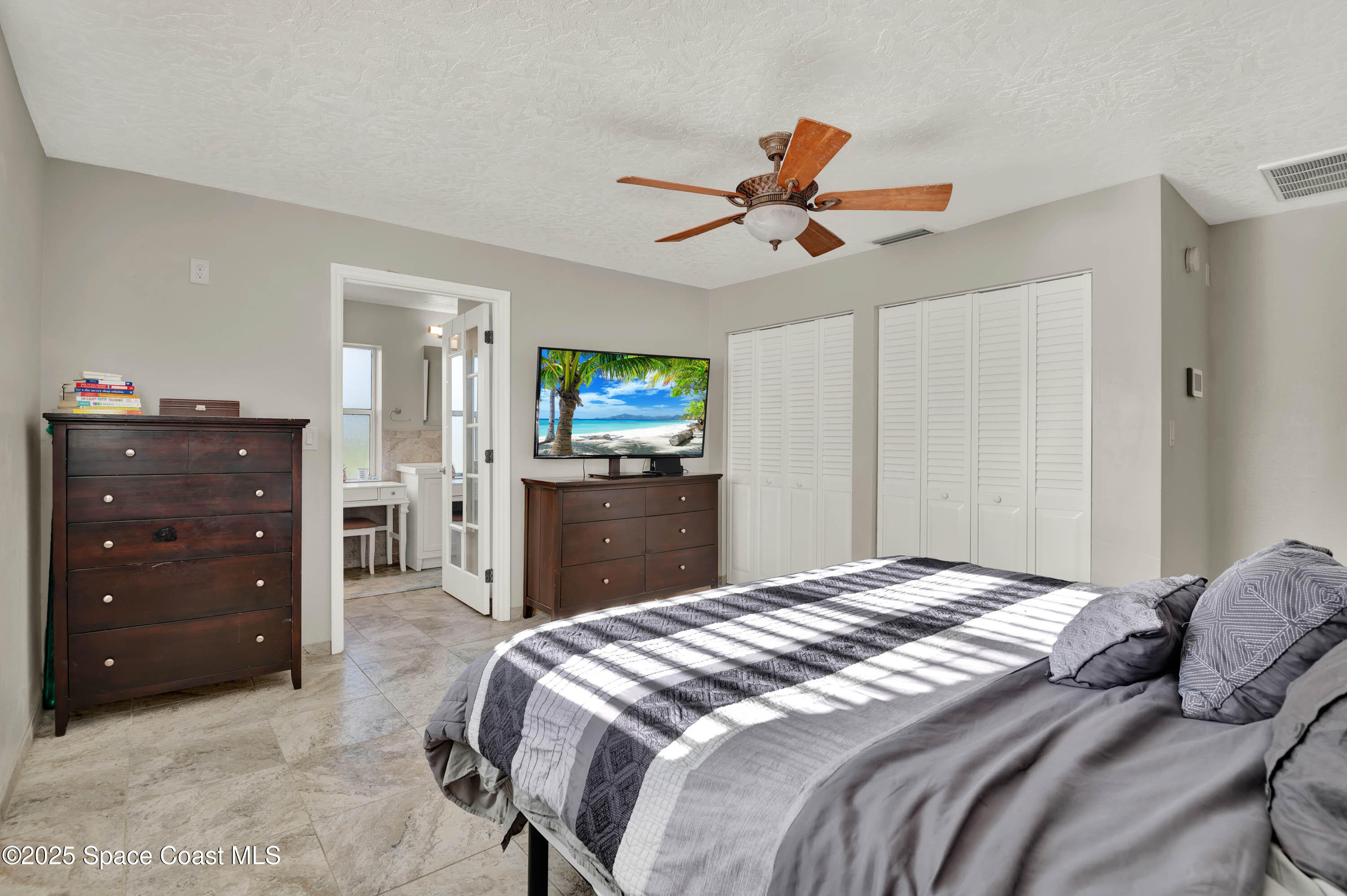 930 Miller Lane Melbourne, FL 32934 - Photo 16 of 40 a bedroom with a bed and a dresser