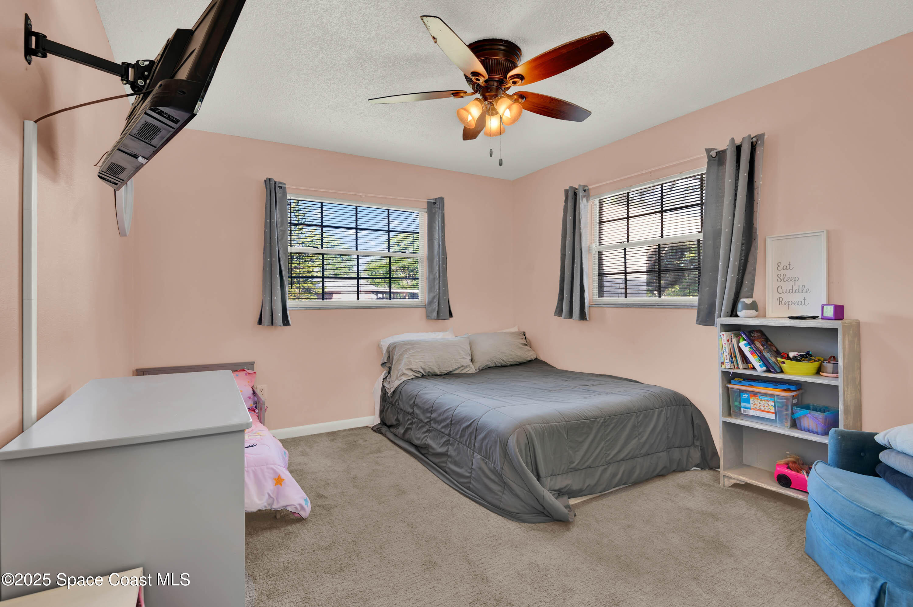 930 Miller Lane Melbourne, FL 32934 - Photo 19 of 40 a bedroom with a bed gym equipment and a window