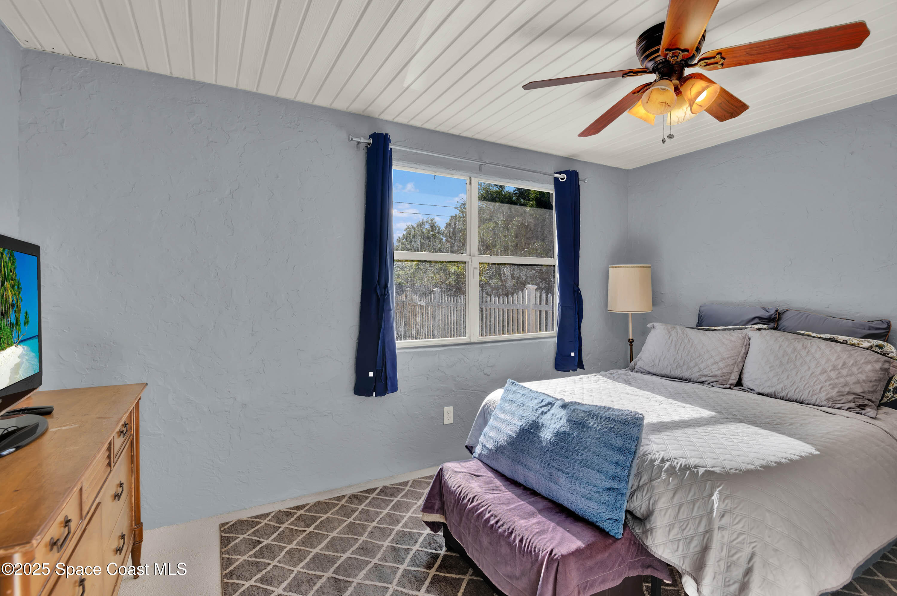 930 Miller Lane Melbourne, FL 32934 - Photo 24 of 40 a bedroom with a bed dresser and a window