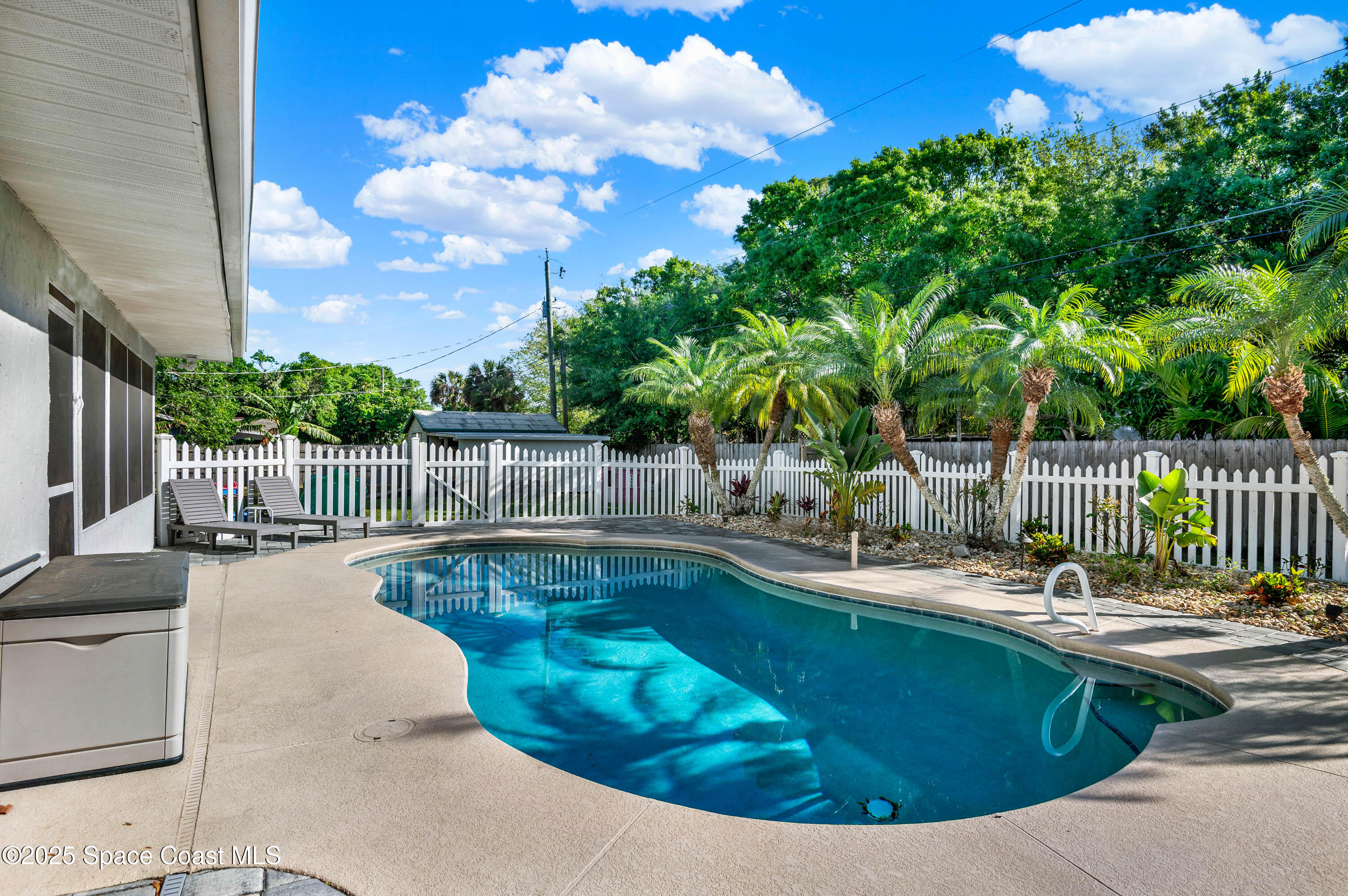 930 Miller Lane Melbourne, FL 32934 - Photo 28 of 40 a view of a swimming pool with a lounge chair