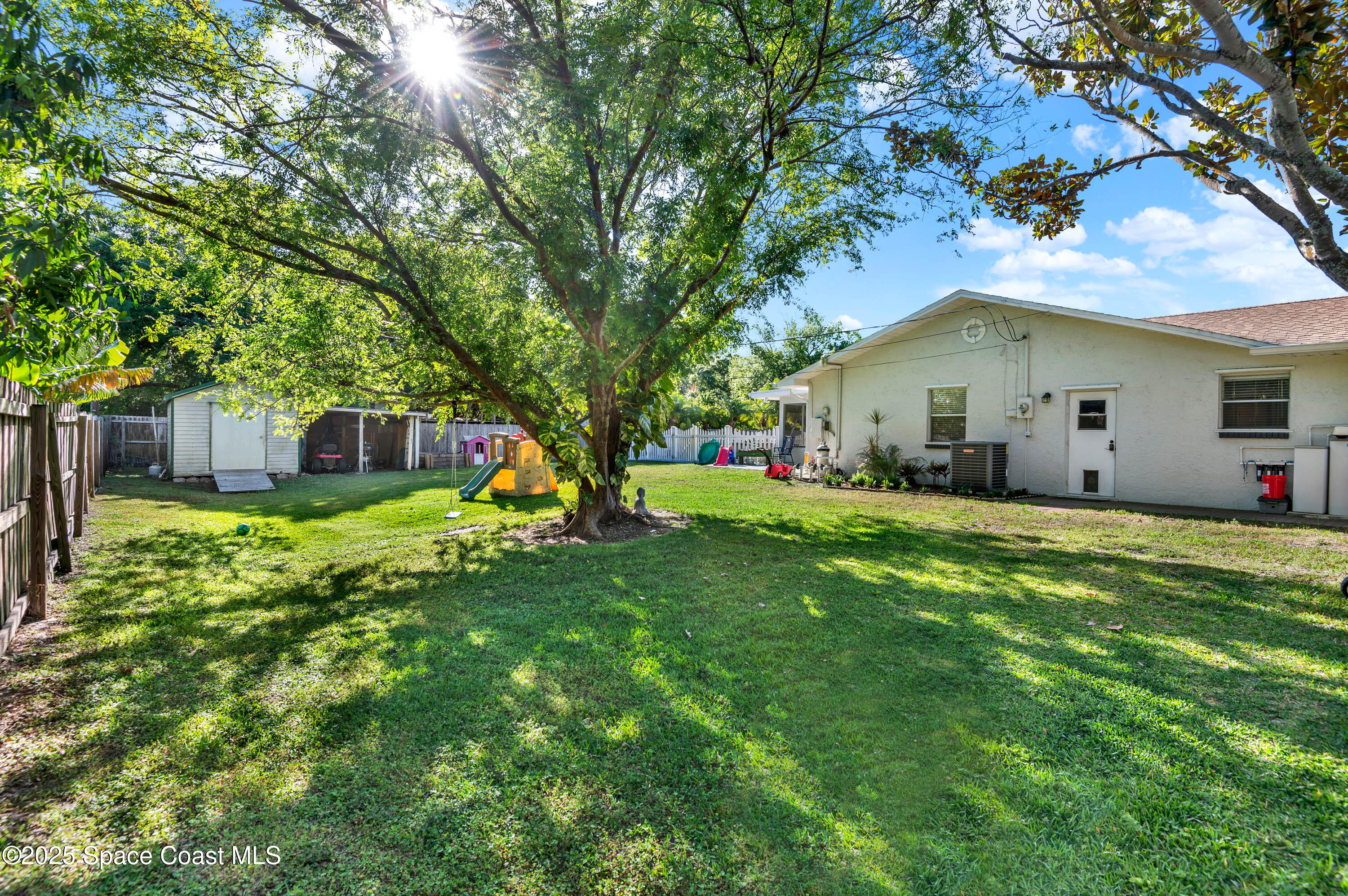 930 Miller Lane Melbourne, FL 32934 - Photo 31 of 40 a front view of house with yard and green space