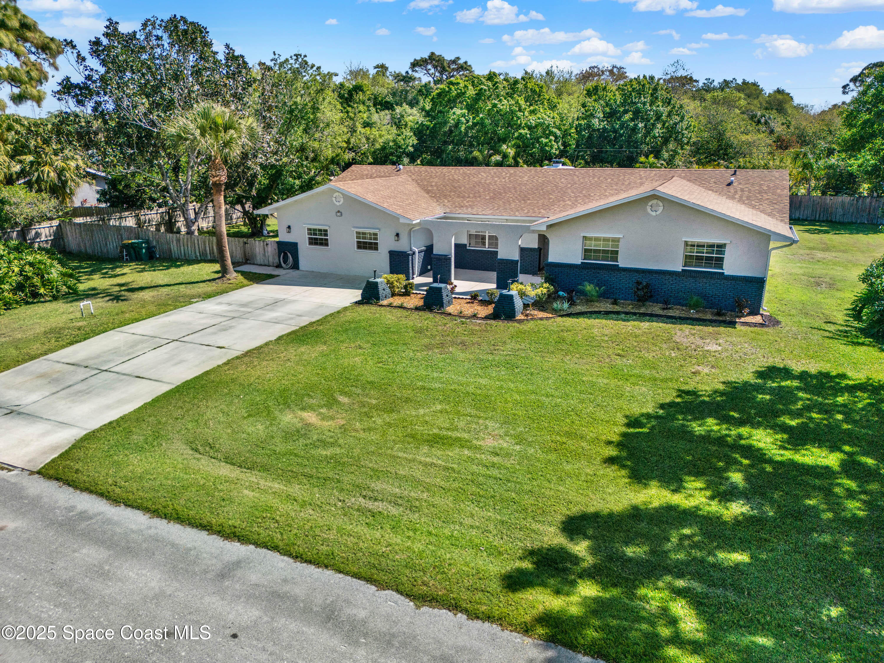 930 Miller Lane Melbourne, FL 32934 - Photo 34 of 40 a aerial view of a house with swimming pool and large trees