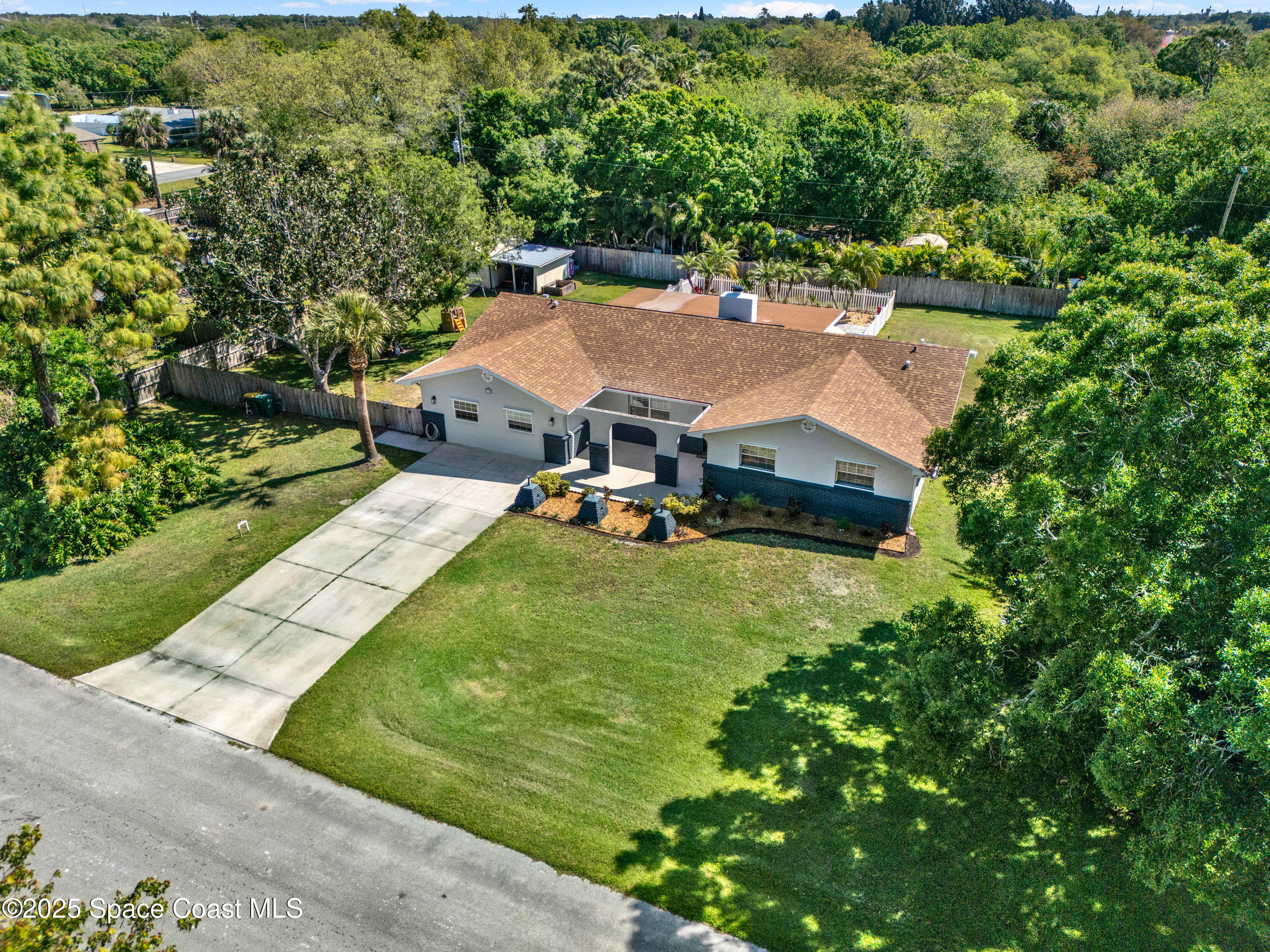 930 Miller Lane Melbourne, FL 32934 - Photo 39 of 40 an aerial view of a house with garden space and street view