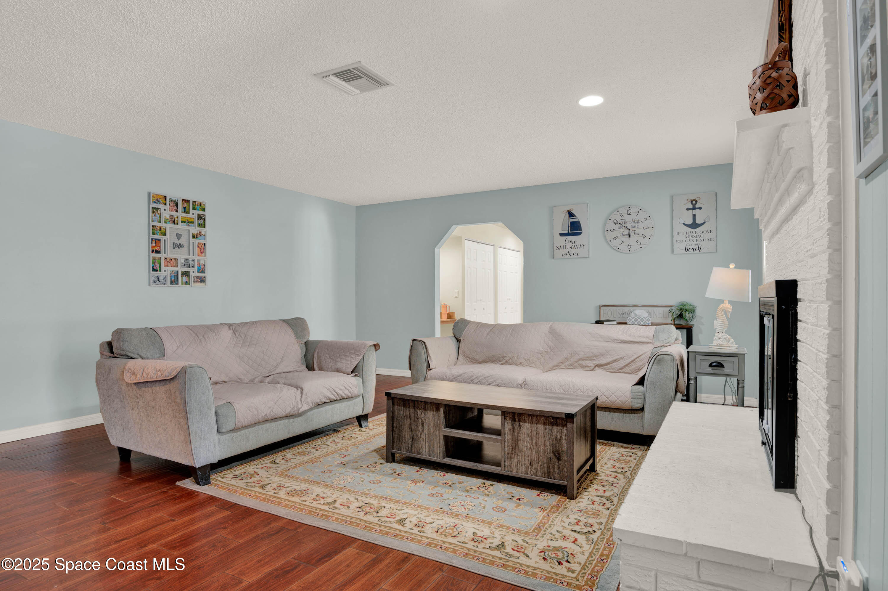 930 Miller Lane Melbourne, FL 32934 - Photo 6 of 40 a living room with furniture and wooden floor
