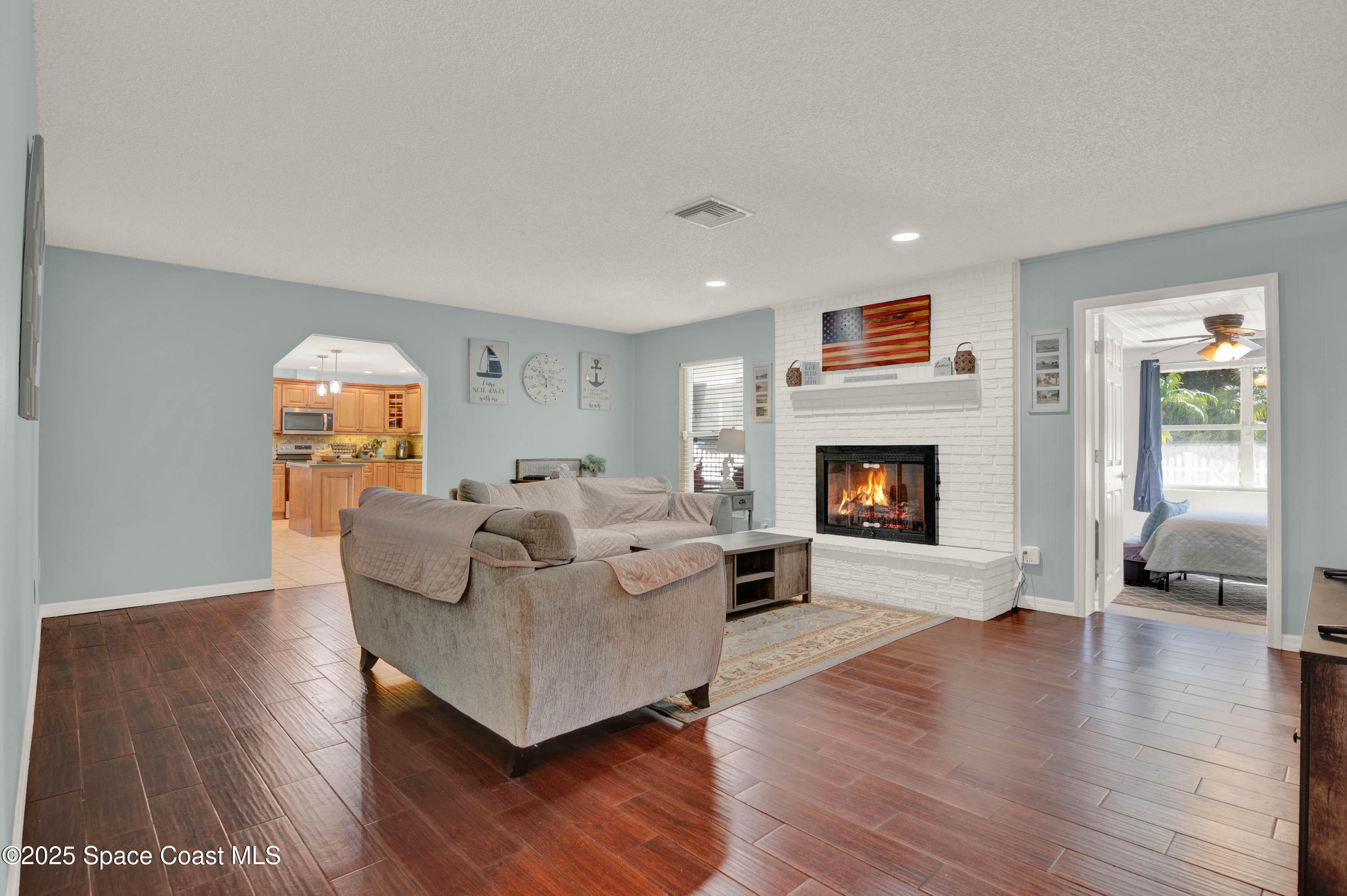930 Miller Lane Melbourne, FL 32934 - Photo 7 of 40 a living room with furniture and a fireplace