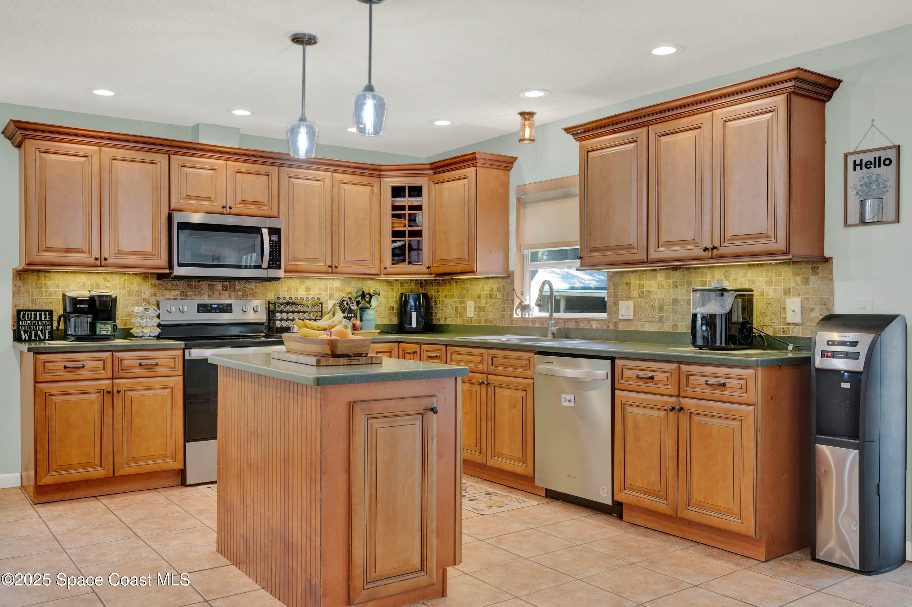 930 Miller Lane Melbourne, FL 32934 - Photo 9 of 40 a kitchen with granite countertop a stove top oven a sink dishwasher and a microwave oven with wooden cabinets
