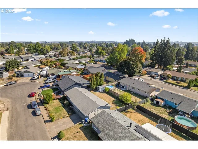 an aerial view of a house with a yard basket ball court and outdoor seating