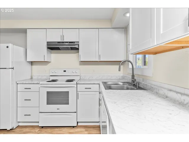 a kitchen with appliances cabinets and a sink