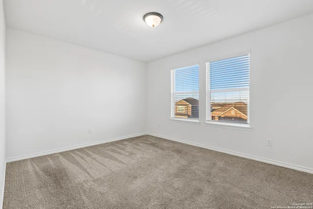 an empty room with windows and window