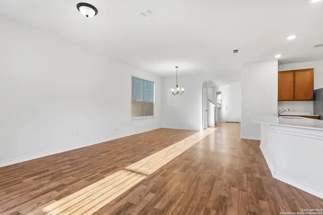 a view of a kitchen with wooden floor and a sink