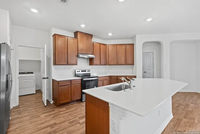 a kitchen that has a sink and a stove in it