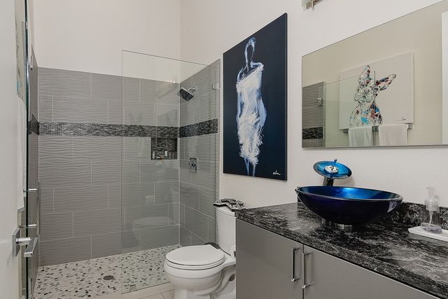 a bath room with a toilet and a shower curtain