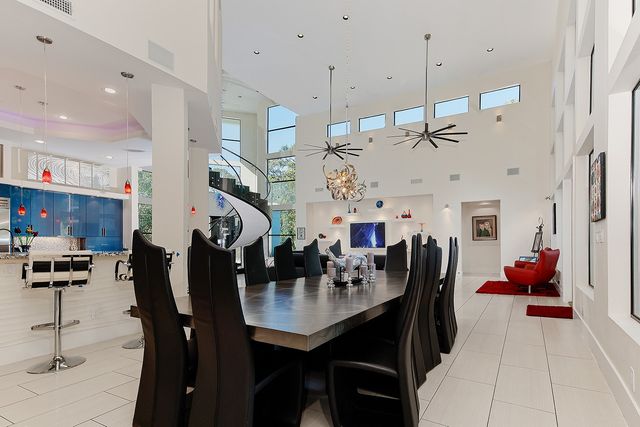 a view of a dining room with furniture and a chandelier
